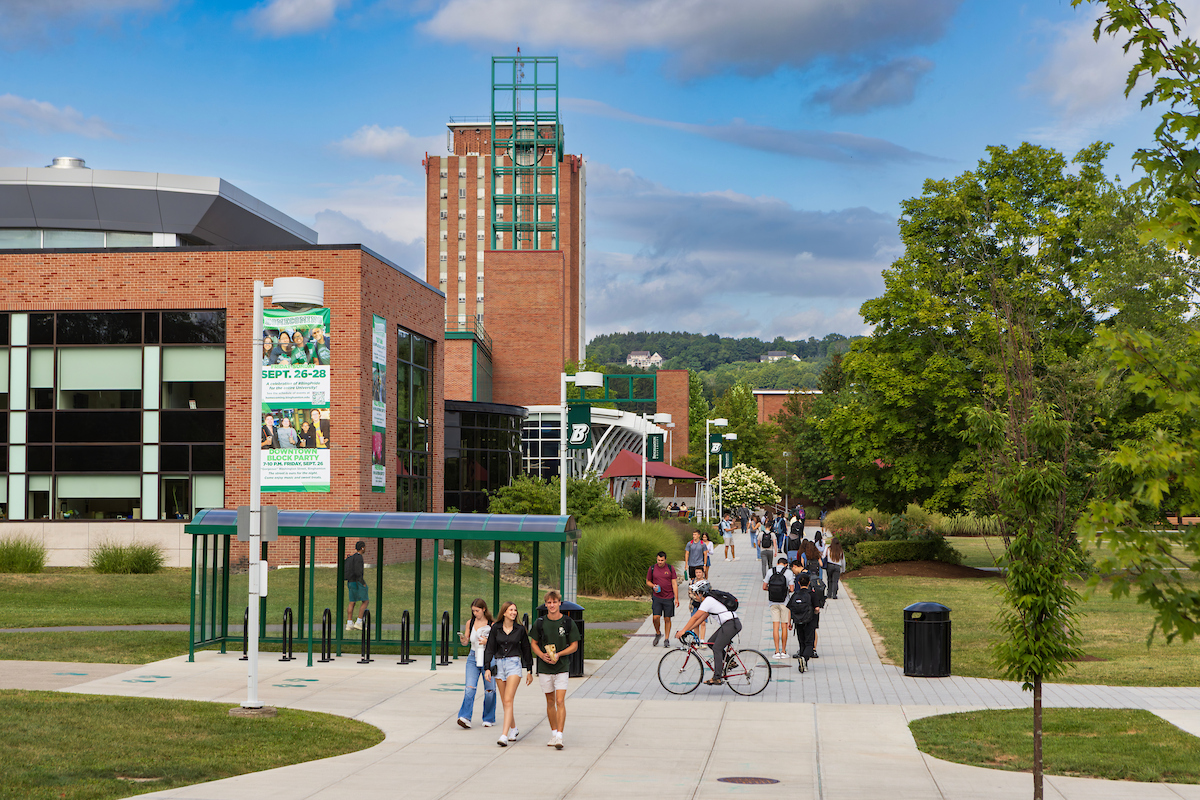 SUNY Binghamton campus — students on the academic plaza with the Bartle Library tower in the background